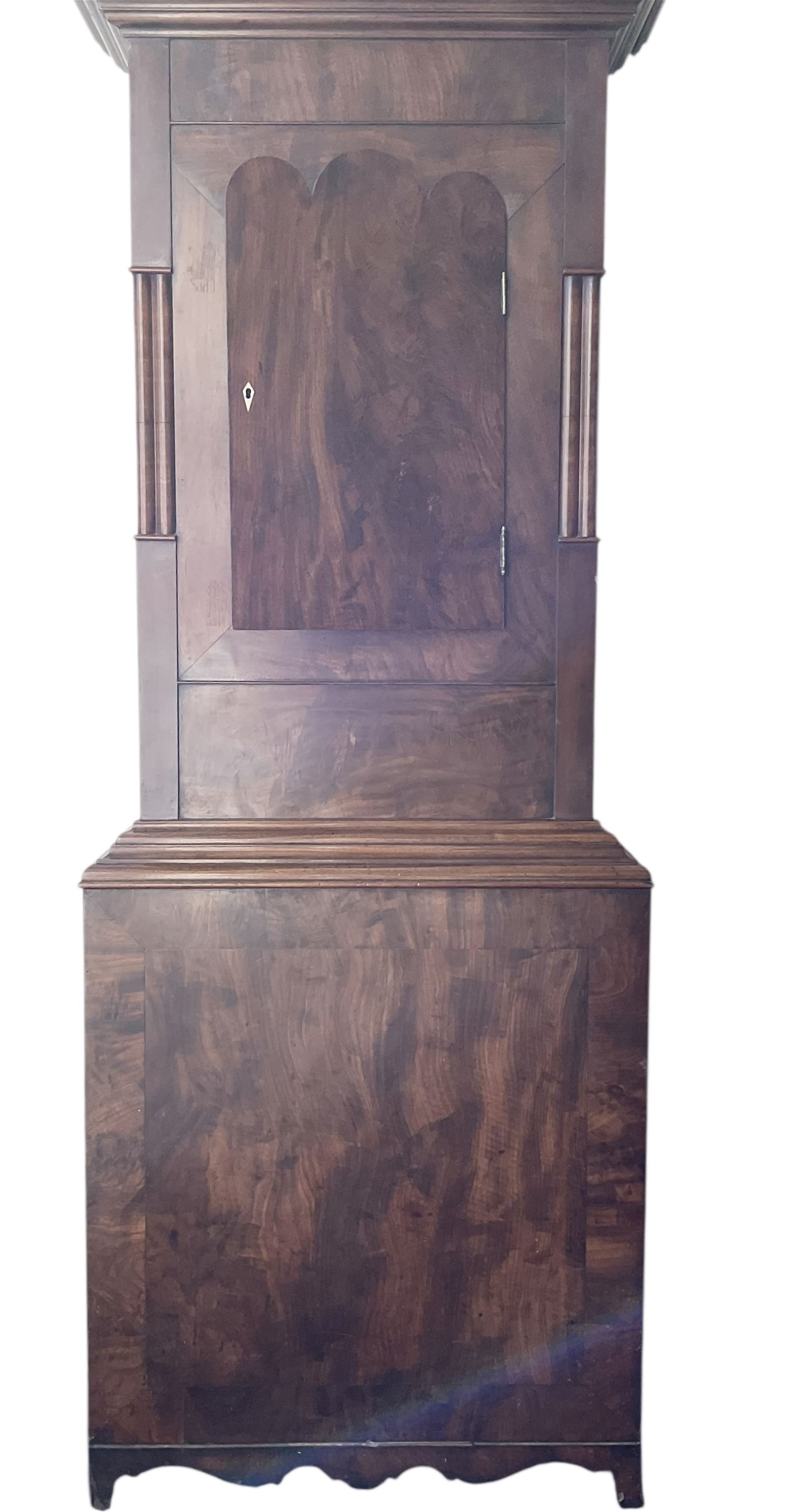 S Marshall of Saley Hill - late Victorian eight day mahogany longcase clock c1860, with a swan necked pediment and brass spire finials, break arch hood door beneath flanked by ring turned pilasters, trunk with inset twin columns and a short three spire door, on a broad plinth with a shaped base, fully painted dial with depictions of cottages to the spandrels and a rural scene to the arch, with Roman numerals , brass hands, seconds and calendar dials, dial pinned directly to a rack striking movement, sounding the hours on a bell. With weights and pendulum.