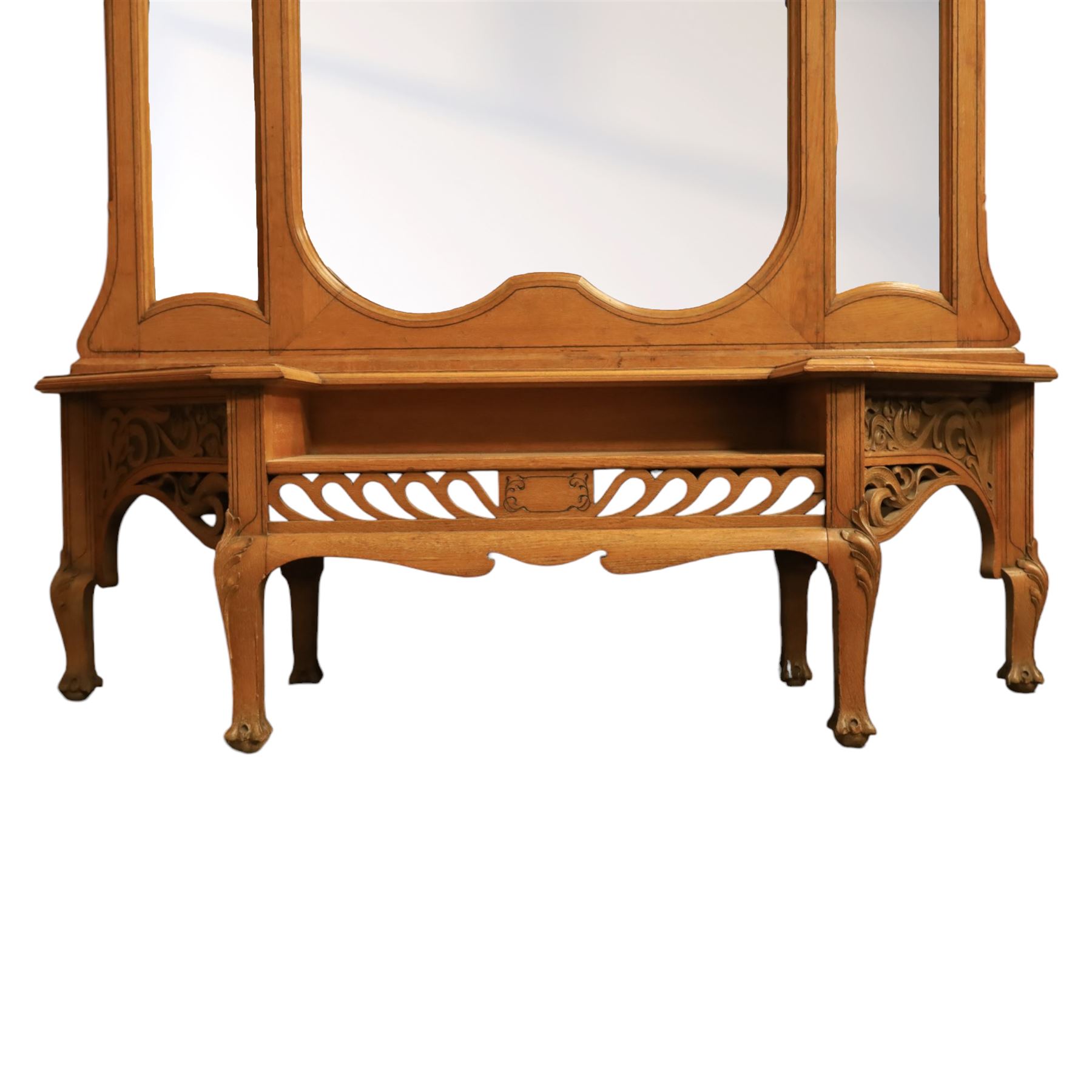 Art Nouveau oak hall mirror, the scrolling frame with large central bevelled mirror plate, boardered by six small mirrors with four shelves between, the base, with carved and pierced floral decoration, upon six cabriole legs   