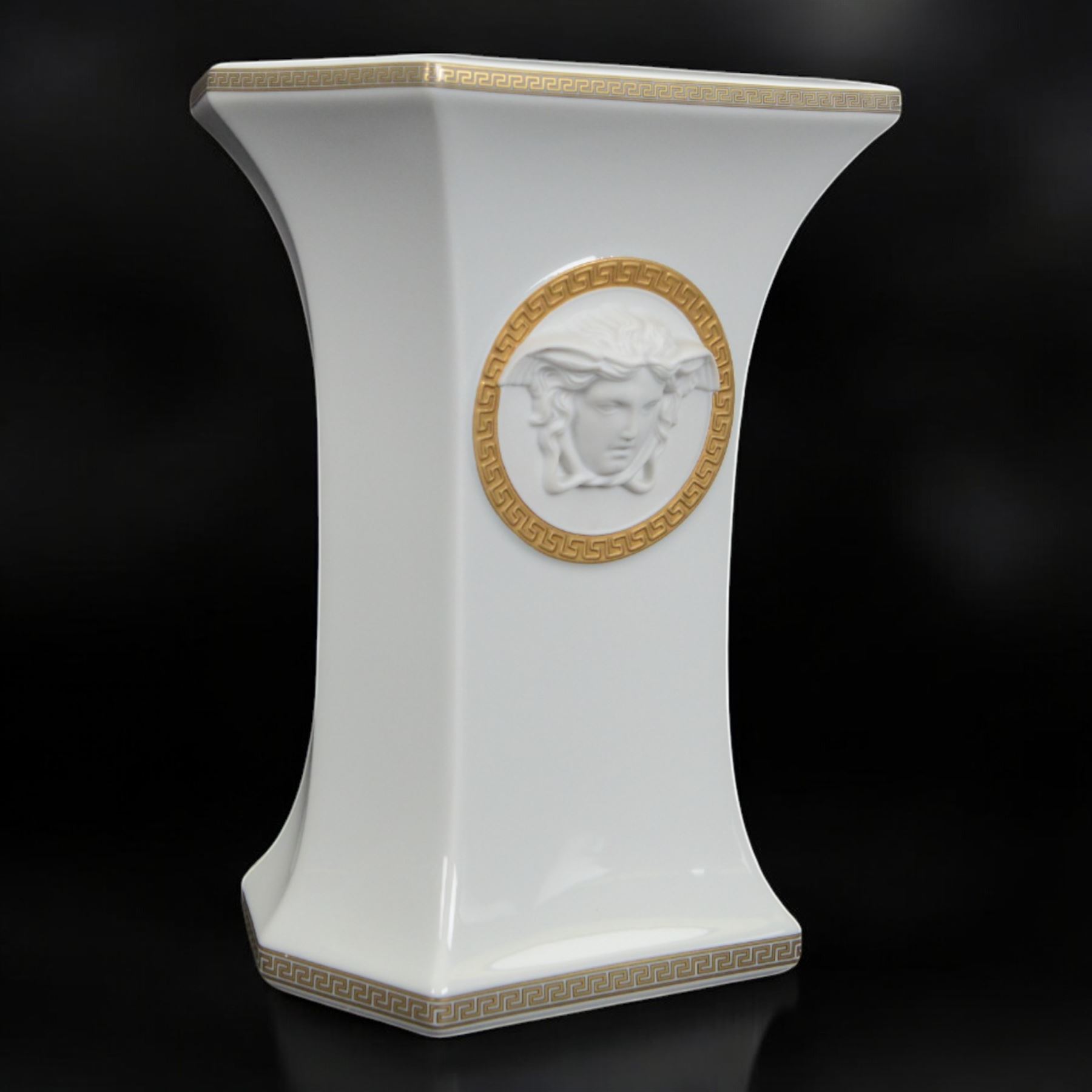 Rosenthal Versace Gorgona vase, of rectagular form with fluted base and rim, decorated in relief with medusa masks and gilt greek key borders upon a white ground, boxed, H23cm