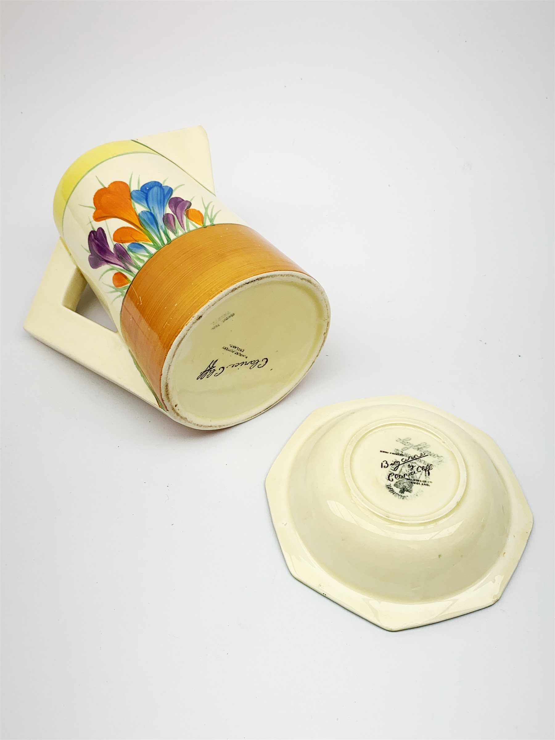 A Clarice Cliff Newport Pottery jug, decorated in the Crocus pattern, H16.5cm, together with a Clarice Cliff Bizarre by Wilkinson Limited octagonal bowl, decorated in the Crocus pattern, D13cm, each with printed marks beneath. 