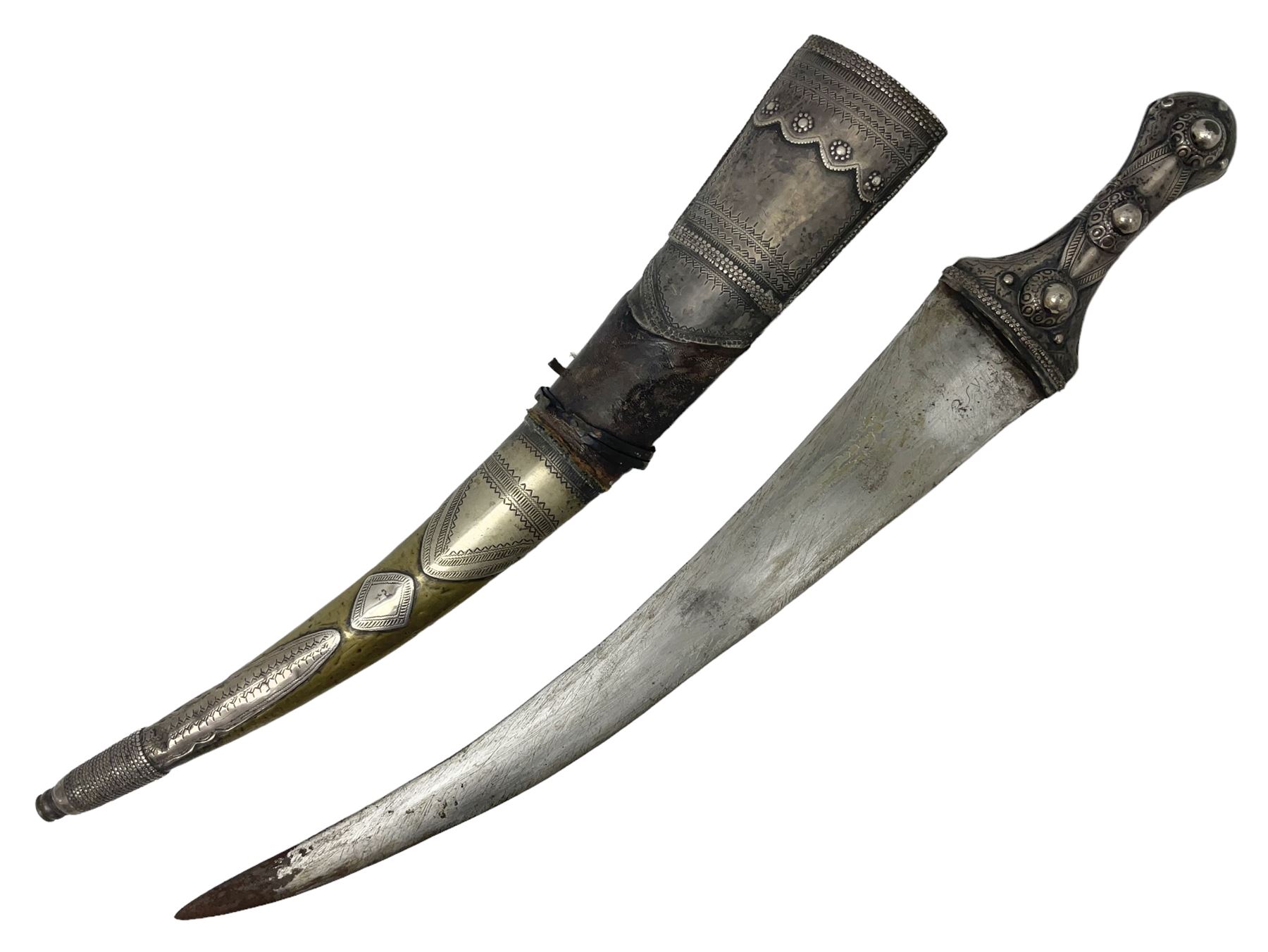 Late 19th/20th century Middle Eastern jambiya dagger the 36cm broad curved double edged steel blade with traces of script, horn and copper backed waisted white metal hilt with three roundel buttons; in ornate white metal and leather mounted brass and steel scabbard L60.5cm overall