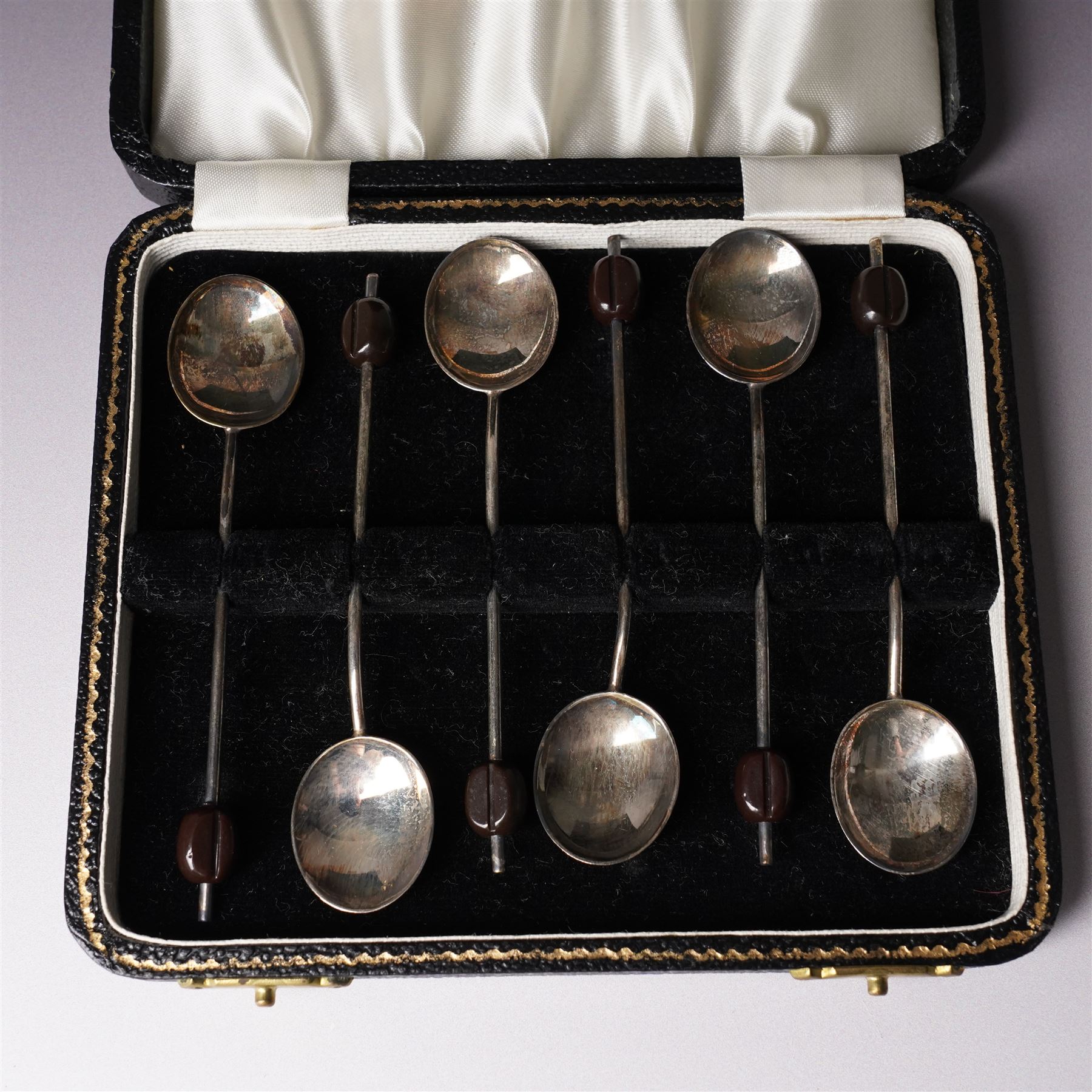 Set of six silver seal top coffee spoons and tongs Sheffield 1924 Maker Cooper Bros & Sons Ltd, cased and a set of six silver bead knop coffee spoons, cased