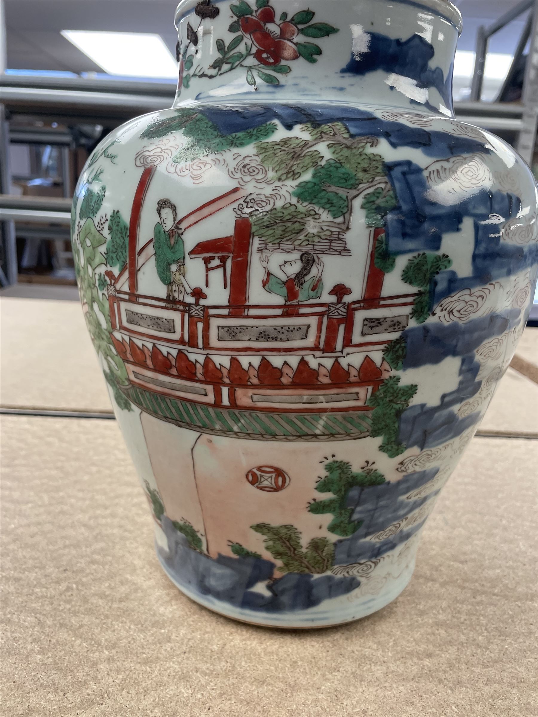 17th century Transitional period Chinese Wucai vase and cover, of baluster form, the body painted with ladies upon a terrace, and figures upon horseback and attendants within a fenced garden, the domed cover with knop finial painted with boys at play, H37cm
