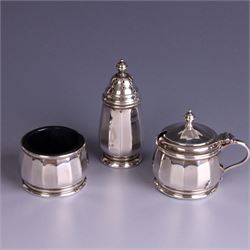Mid 20th century three piece silver cruet set, comprising pepper shaker, open salt and mustard pot with cover, each of circular faceted form, hallmarked Walker & Hall, Birmingham 1958, the mustard pot and salt with blue glass liners