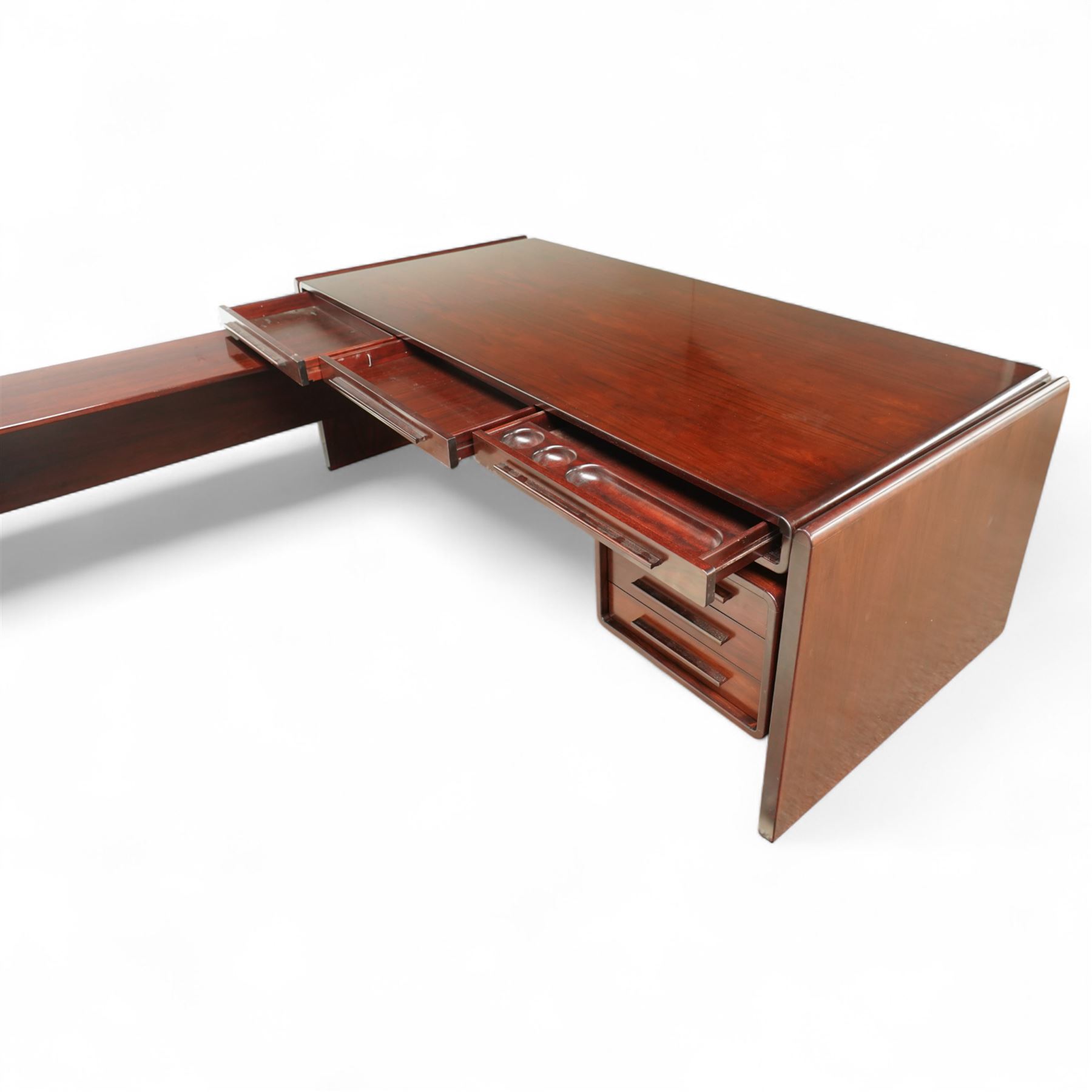 Dyrlund - contemporary Santos rosewood executive desk set, main desk with a rectangular top and leather writing pad above, floating drawer unit with right-angled desk unit top with document tray above a filing drawer 

Note: Dyrlund is a Danish furniture manufacturer known for its high-quality, handcrafted pieces, particularly in the mid-century modern style. Founded in 1960 by Frits Hjerte Dyrlund in Rude, Denmark, the company has remained a family business, now run by the second and third generations. Dyrlund specializes in both home and executive office furniture, focusing on practicality, solid construction, and classic design