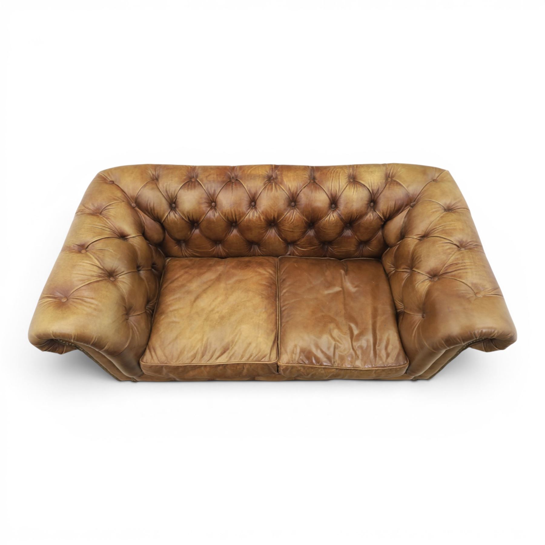 HALO - Chesterfield style two seat sofa upholstered in buttoned brown leather with stud work, on turned feet with castors