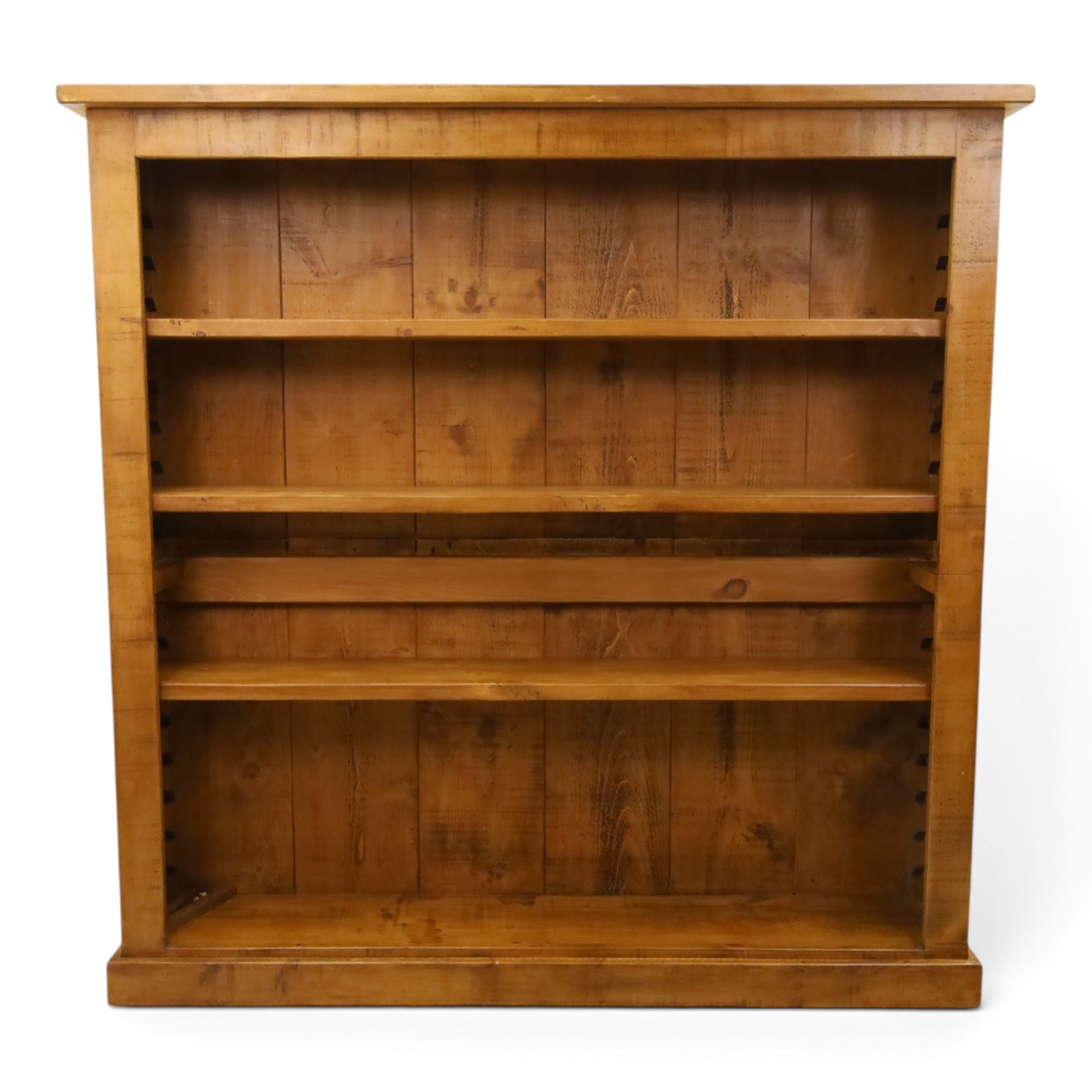 Indigo Furniture - large rustic oak open bookcase, with four adjustable shelves, above a plinth base 