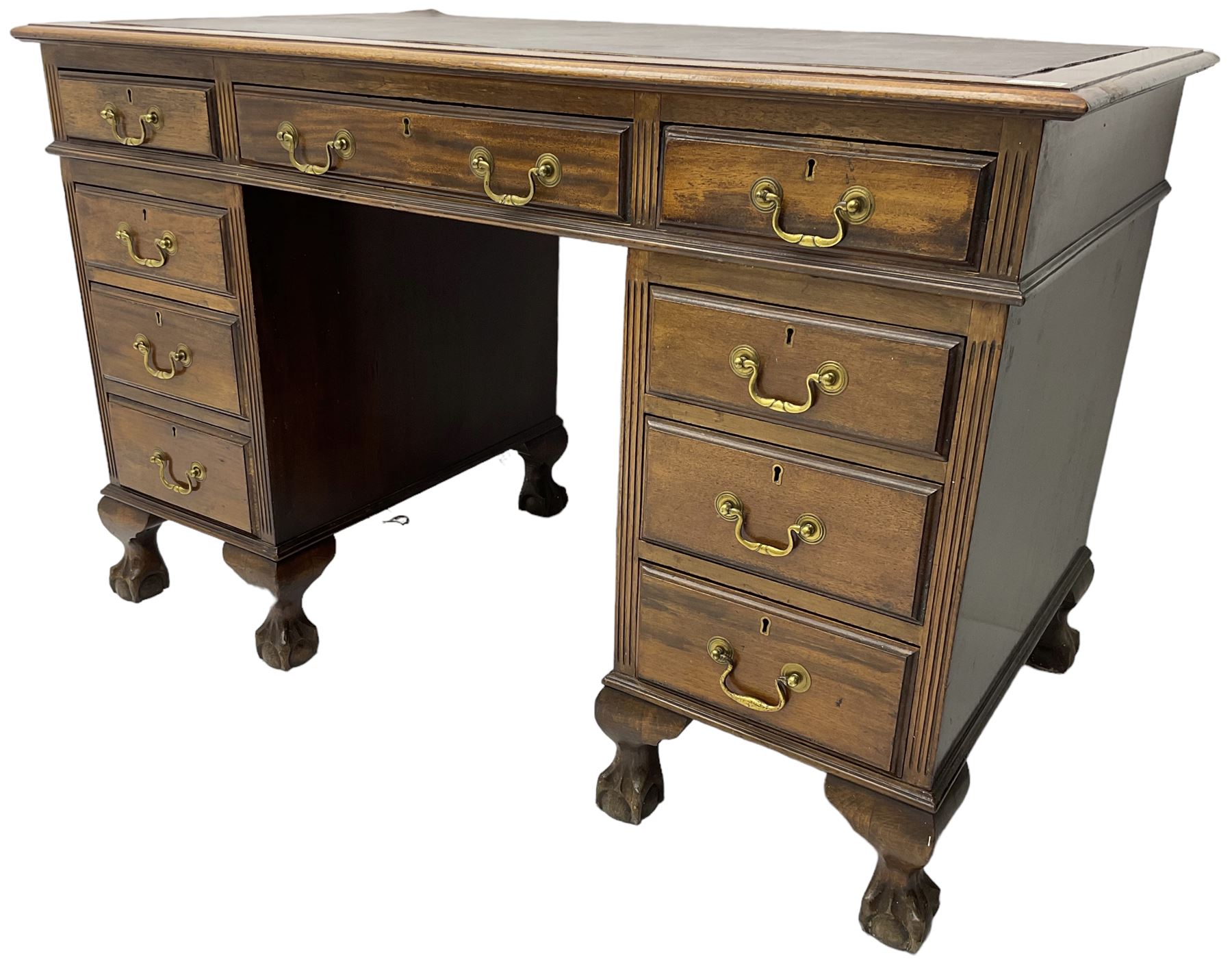 Early 20th century mahogany twin pedestal desk, fitted with nine drawers, on ball and claw carved cabriole feet