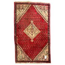 Small Persian red ground rug, lozenge medallion surrounded by small Boteh motifs