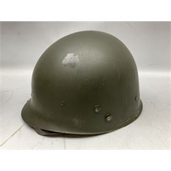 American first type paratrooper helmet with post-WW2 strap and D-rings and later 1944 liner bearing Firestone Tyre and Rubber Company mark; green textured finish
