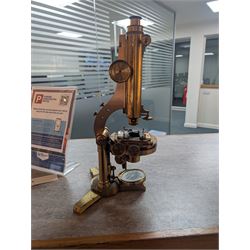 19th century brass binocular microscope by R&J Beck, 31 Cornhill London, numbered 6386, with rack and pinion focusing, housed in wooden case with case of accessories, including eyepieces, objective lenses and condenser