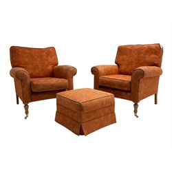Pair traditional shape armchairs, upholstered in burnt orange fabric, on turned beech supports with brass castors (W85cm, H96cm, D92cm), together with matching footstool (54cm x 54cm, H37cm)