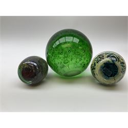 Group of glass paperweights, to include large green example with internal bubble decoration, four Mdina examples, etc. 