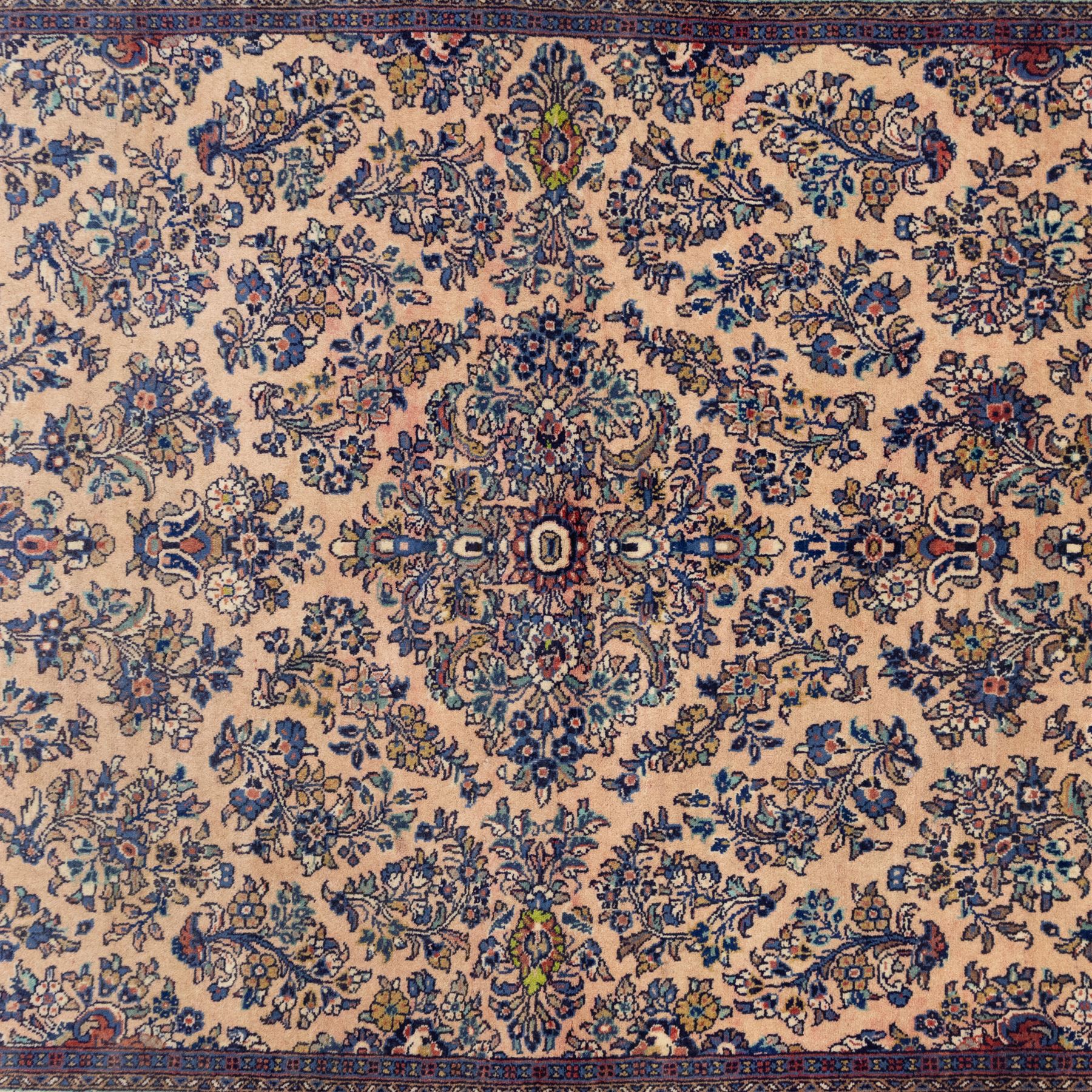Central Persian Nain hand-knotted rug, ivory ground decorated with a central lobbed medallion and an all-over floral and foliate design of stylised palmettes, flowering plants, and scrolling vine work, enclosed by a contrasting main border with repeating floral motifs, flanked by multiple guard borders, with cotton fringe ends 
