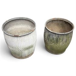 Two20th century galvanised metal dolly tubs, with rolled rims above corrugated bodies centred by chevron bands and circular bases, max W48cm H52cm)