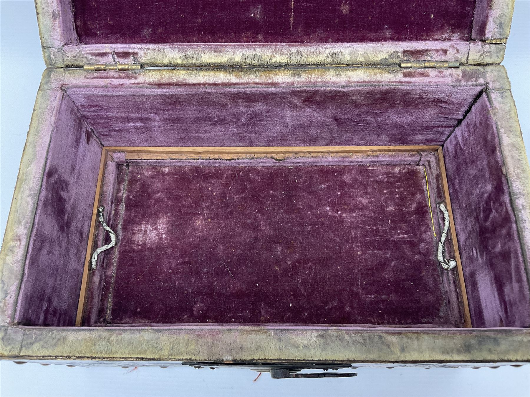 20th century box, decorated in faux leather with the royal coat of arms and GR 1719 to hinged cover, with fleur-de-lis, lion, crown and rose motifs throughout and studs to all edges, opening to reveal a purple velvet interior containing three removable wooden trays, H18.5cm
