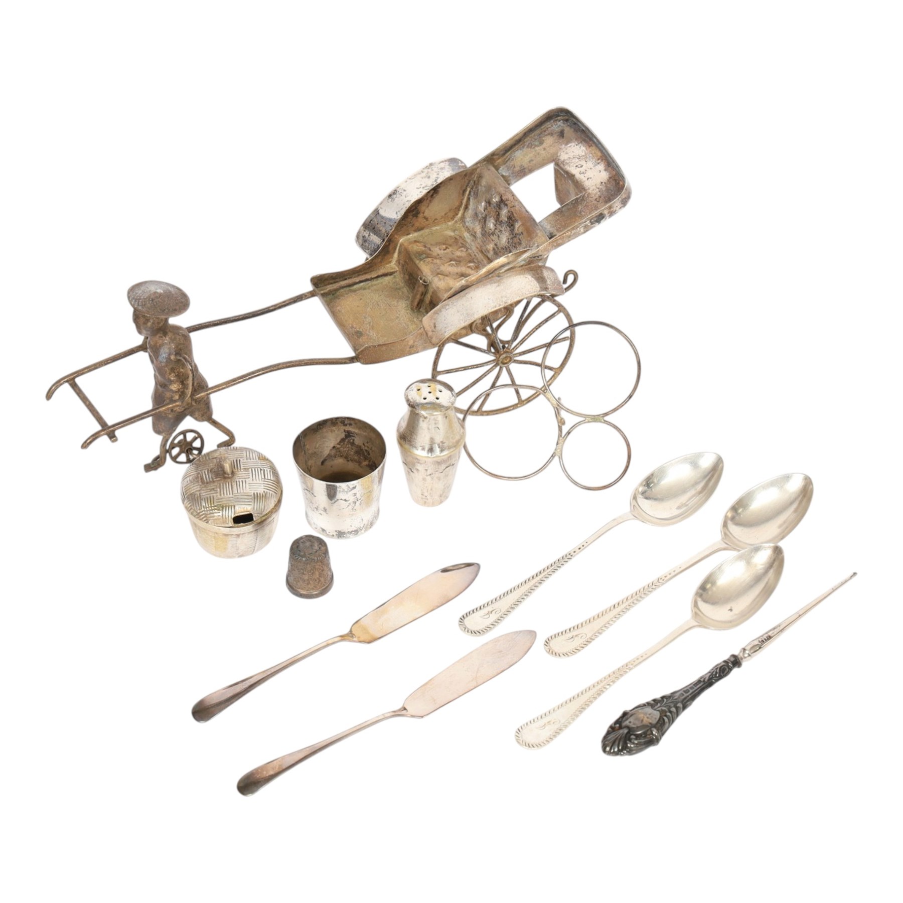 Silver cutlery comprising three teaspoons and two butter knives, a silver handled hook and a silver plated Chinese rickshaw cruet