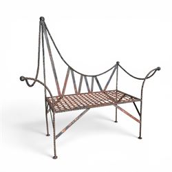 Victorian design wrought iron garden bench, with asymmetrical rope-twist frame, arched back and sides over out-swept arm terminals with ball finials, flanking a lattice seat, in antique black-painted weathered finish
