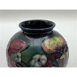 Three pieces of Moorcroft Pottery, comprising pot and cover of cylindrical form decorated in the Orchid pattern, H9cm, and two vases, the first example of ovoid form decorated in the Orchid pattern, the second decorated in the Clematis pattern, each with impressed marks beneath