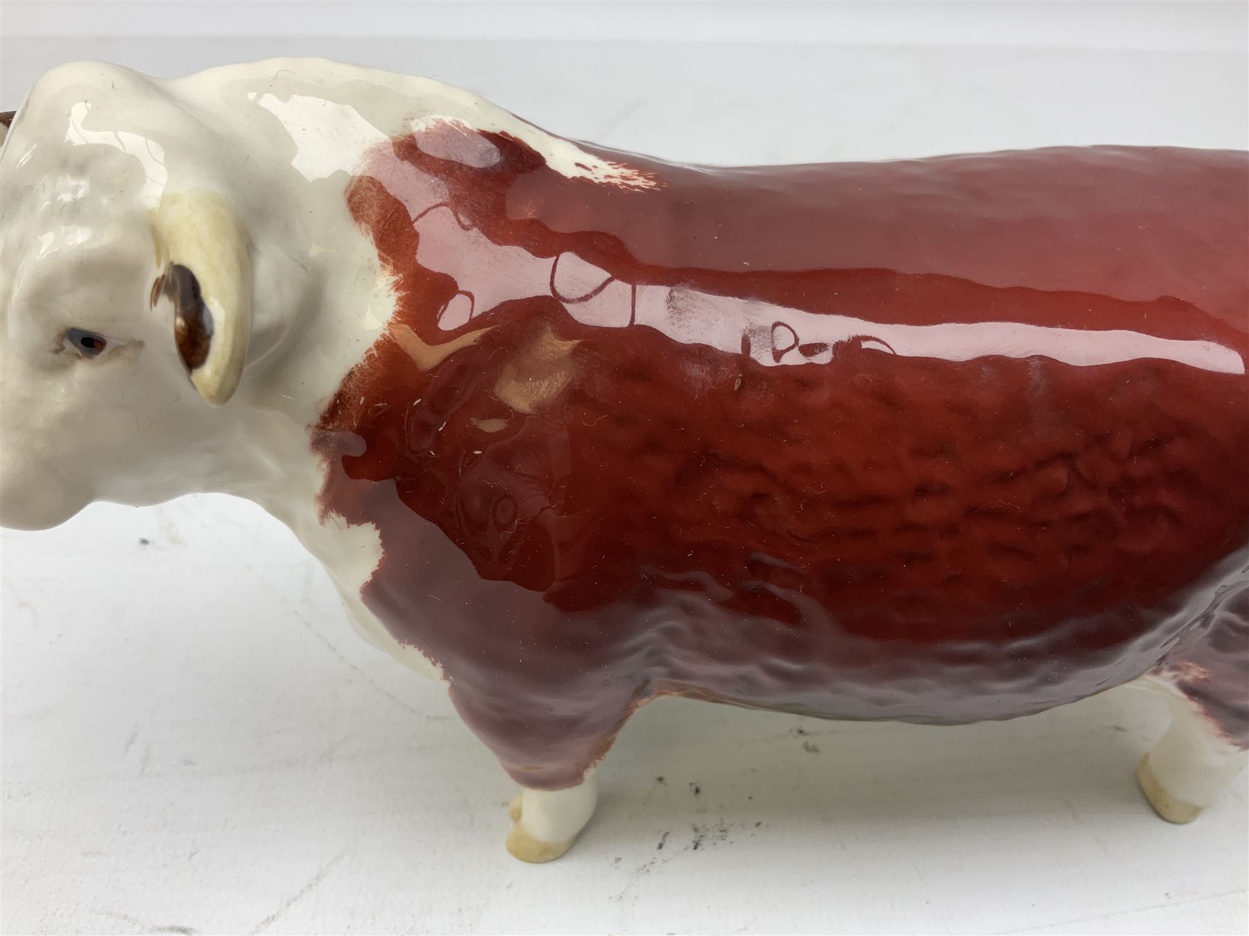 Three Beswick models comprising Hereford Bull no 949, 'CH Cutmil Cupie' Pug, and bay Shire horse, all with printed marks beneath