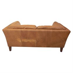Two seat sofa upholstered in tan leather