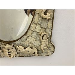 Pair 19th century French Dieppe bone and ivory wall mirrors, the oval bevelled mirror plates within rectangular frames with shaped tops, profusely decorated with ivory leaves, further detailed with carved bone armorial type crest inscribed 'SGOTORVM', putti, fish and mask heads, H81cm W48cm