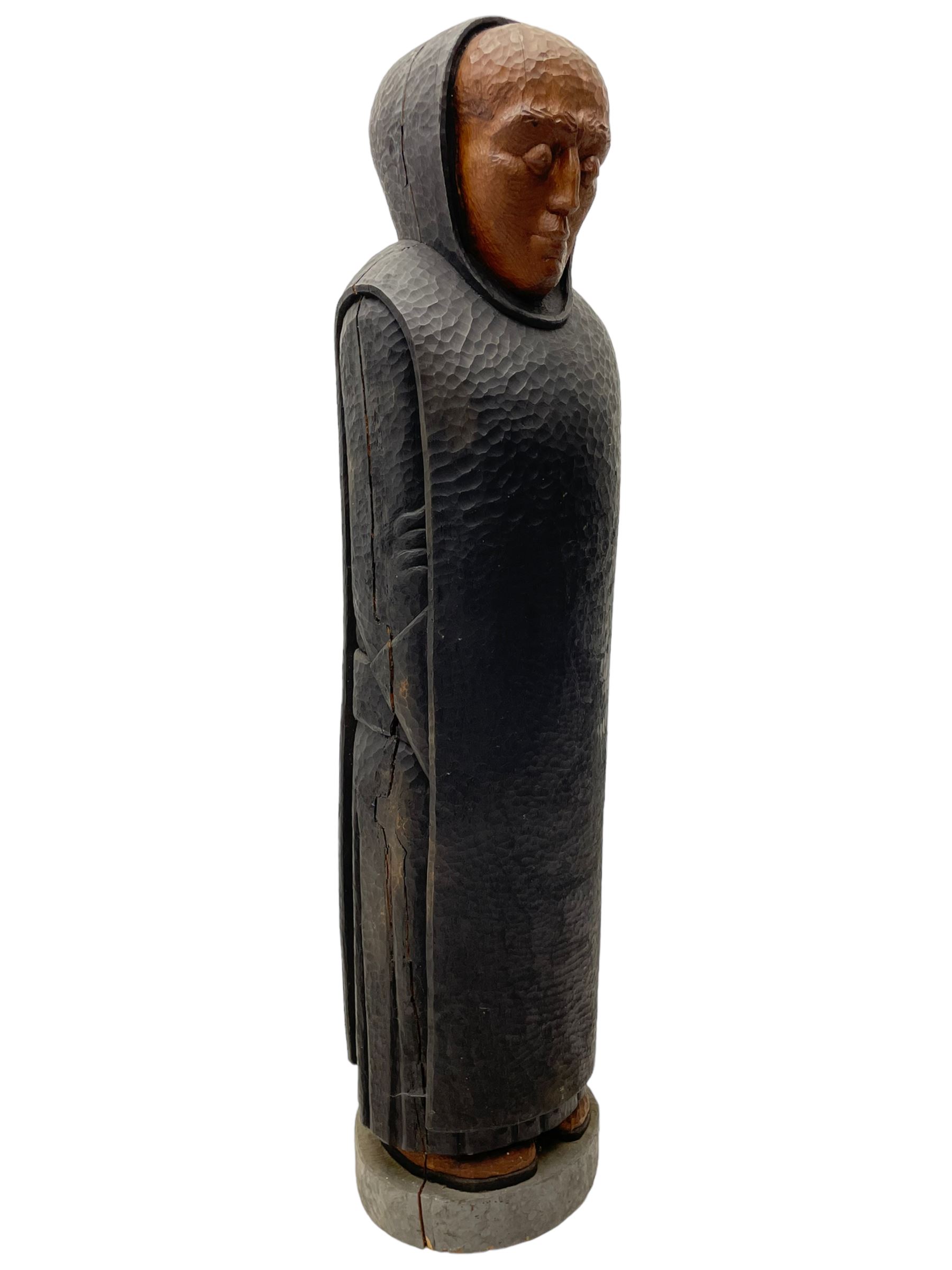 John Bunting FRBS, FRCA (1927-2002): Carved sculpture of a standing Monk in ebonised robes