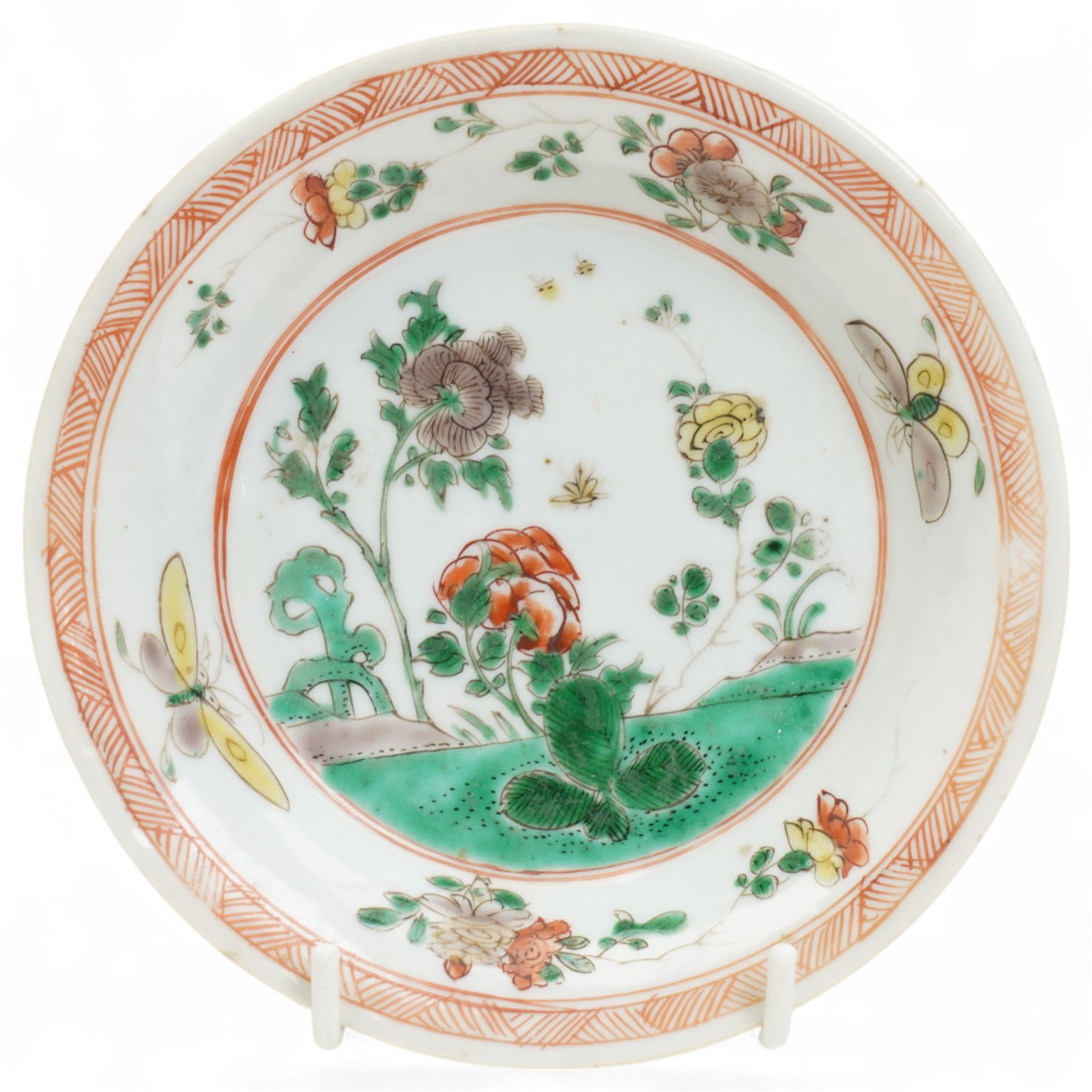 Three Chinese famille verte examples, approximately Yongzheng period, to include two teabowls and two saucers, each decorated with flowers and butterflies, two with sacred fungus mark within double rings, the teabowl with lotus mark, the other indistinct - possibly a Wan mark within lozenge (4)