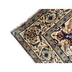 Persian Kashan ivory ground rug, wool with silk inlay, central floral rosette medallion surrounded by trailing flower heads and interlacing leafy branches, the repeating scrolling border decorated with palmettes, within guard stripes