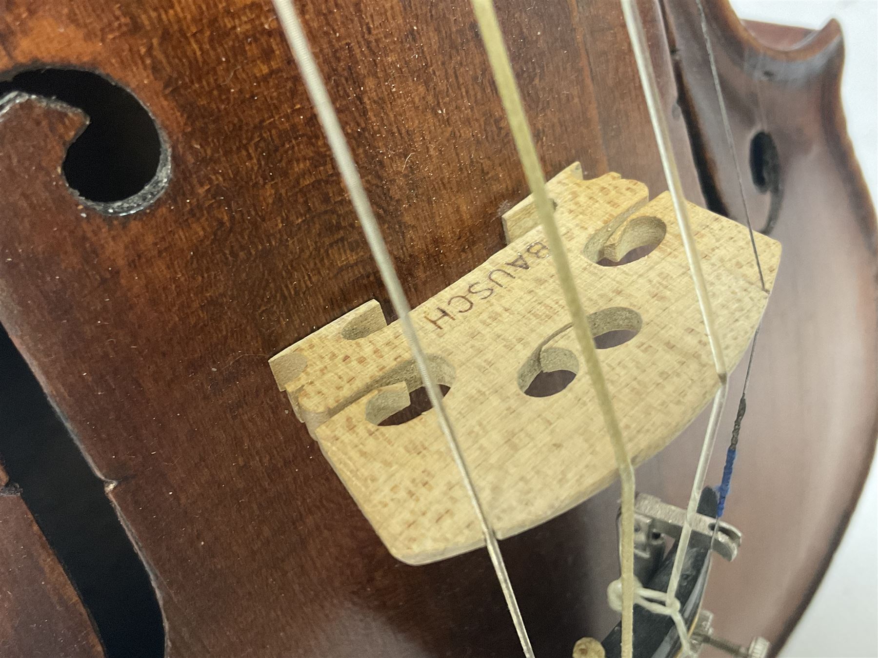 19th century full sized violin in a later hard case, decorative mother of pearl inlay to the tail piece Overall length 60cm No bow