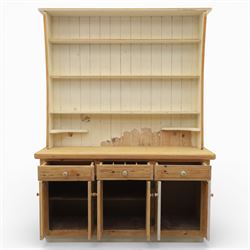 Late 20th century pine and white painted dresser, the upper section with three shelves and boarded back, upon a base with three drawers with knob handles and three panelled cupboard doors, on a raised sled base