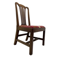 Set of six (5+1) George III mahogany dining chairs, shaped cresting rail over pierced and flared splat, drop-in seat upholstered in crimson and ivory floral patterned fabric, raised on chamfered square supports united by H-stretcher