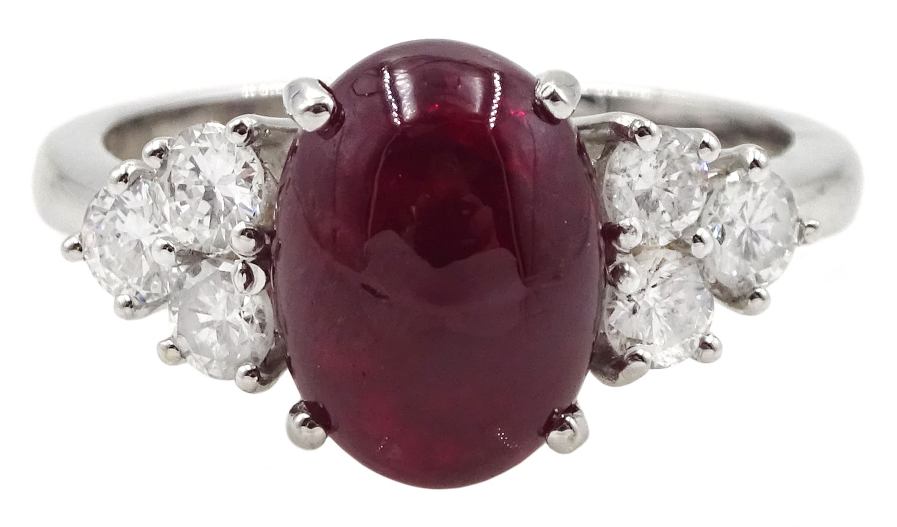 18ct white gold cabochon ruby ring, set with three round brilliant cut diamonds either side, hallmarked, ruby approx 3.20 carat, total diamond weight approx 0.55 carat
