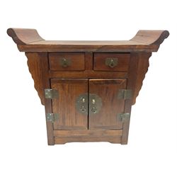 Chinese table top cabinet of altar form, fitted with pair of hinged doors opening to reveal shelved interior below two small drawers, with brass hinges and fittings, H43cm W50cm D25cm