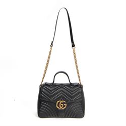Gucci GG Marmont black matelassé leather top handle bag, made in Italy, with chevron quilted leather and heart motif to the reverse, antique gold-tone Double G front hardware, leather top handle and detachable chain shoulder strap with leather shoulder guard, front flap closure, suede-effect interior with zip pocket and leather logo tab stamped Gucci made in Italy, together with original Gucci dust bag and carrier, W27cm D11cm H20cm