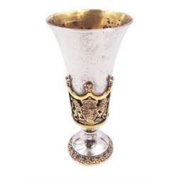 Modern limited edition silver Westminster Abbey Royal Wedding goblet, commemorating the marriage of HRH Prince Andrew and Miss Sarah Ferguson on the 23rd of July 1986, designed by Hector Miller for Aurum, the tapering cylindrical bowl with gilt interior and parcel gilt pierced band to base depicting the Royal Arms, upon knopped stem and circular stepped foot with floral parcel gilt rim, no. 483/750,  hallmarked Hector Miller, London 1986, H17cm