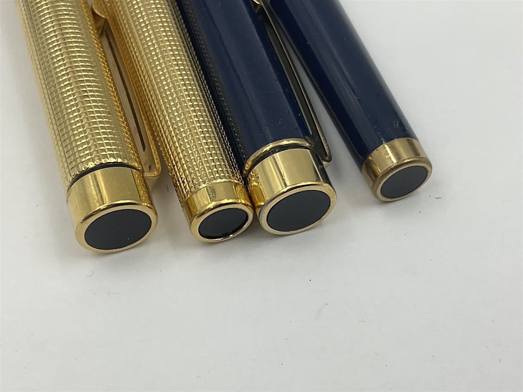 Sheaffer Targa 1011 Diamond Square fountain pen, the gold plated barrel with nib stamped 14K 585, together with another Sheaffer Targa fountain pen with blue barrel and gold nib stamped 14K 585 and matching ballpoint, and Sheaffer ballpoint pen with sterling silver barrel, largest L13.5cm (4)