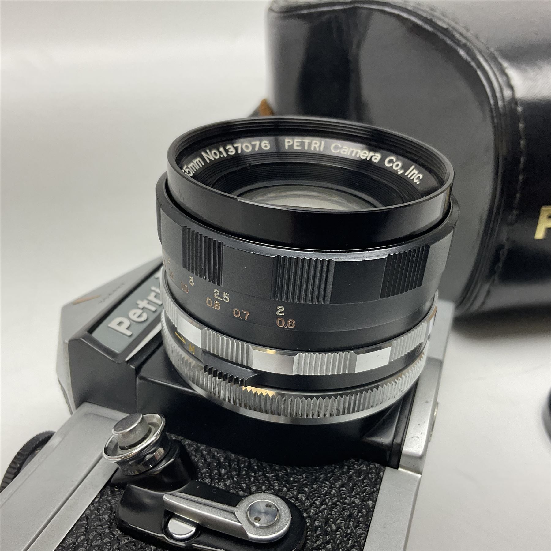 Petri Flex 7 camera body, serial no. 555698, with Perti C.C 1:1.8 f=55mm' lens, serial no. 78253, together with Petri Flex V2 camera body, serial no. 364427, with 'Petti C.C. 1:2 f=55mm' lens, serial no. 137076, in ever ready case