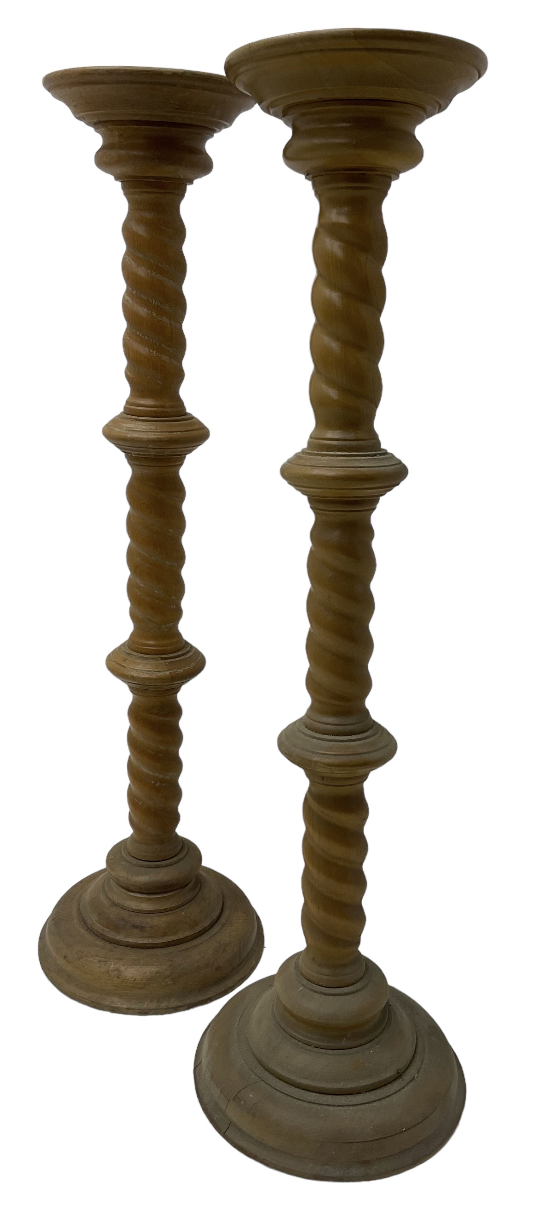 Pair of Victorian design light oak torcheres or jardinieres, circular top with raised lip over a spiral turned column terminating in circular turned plinth base