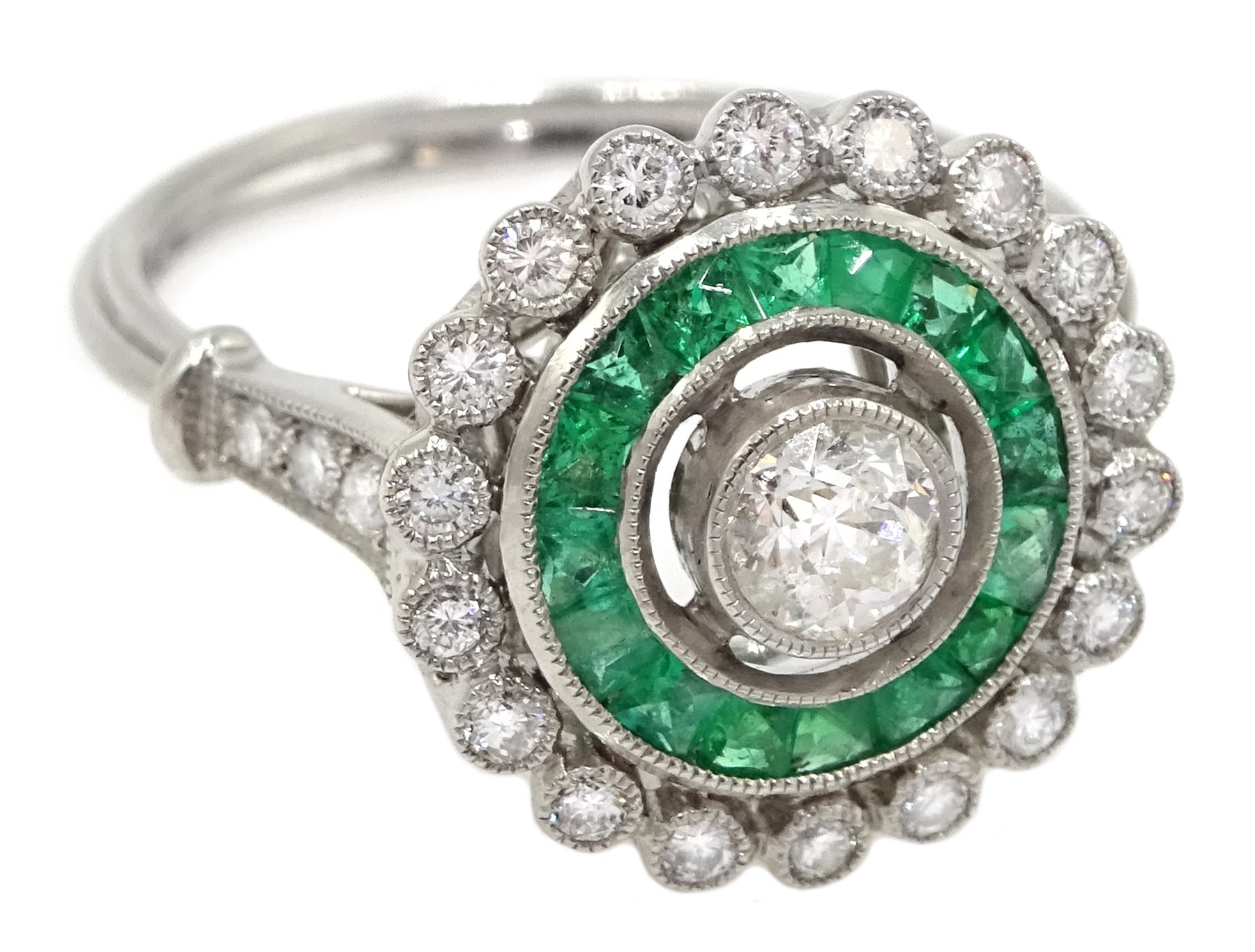 Platinum round diamond and calibre cut emerald target design ring, with diamond set shoulders