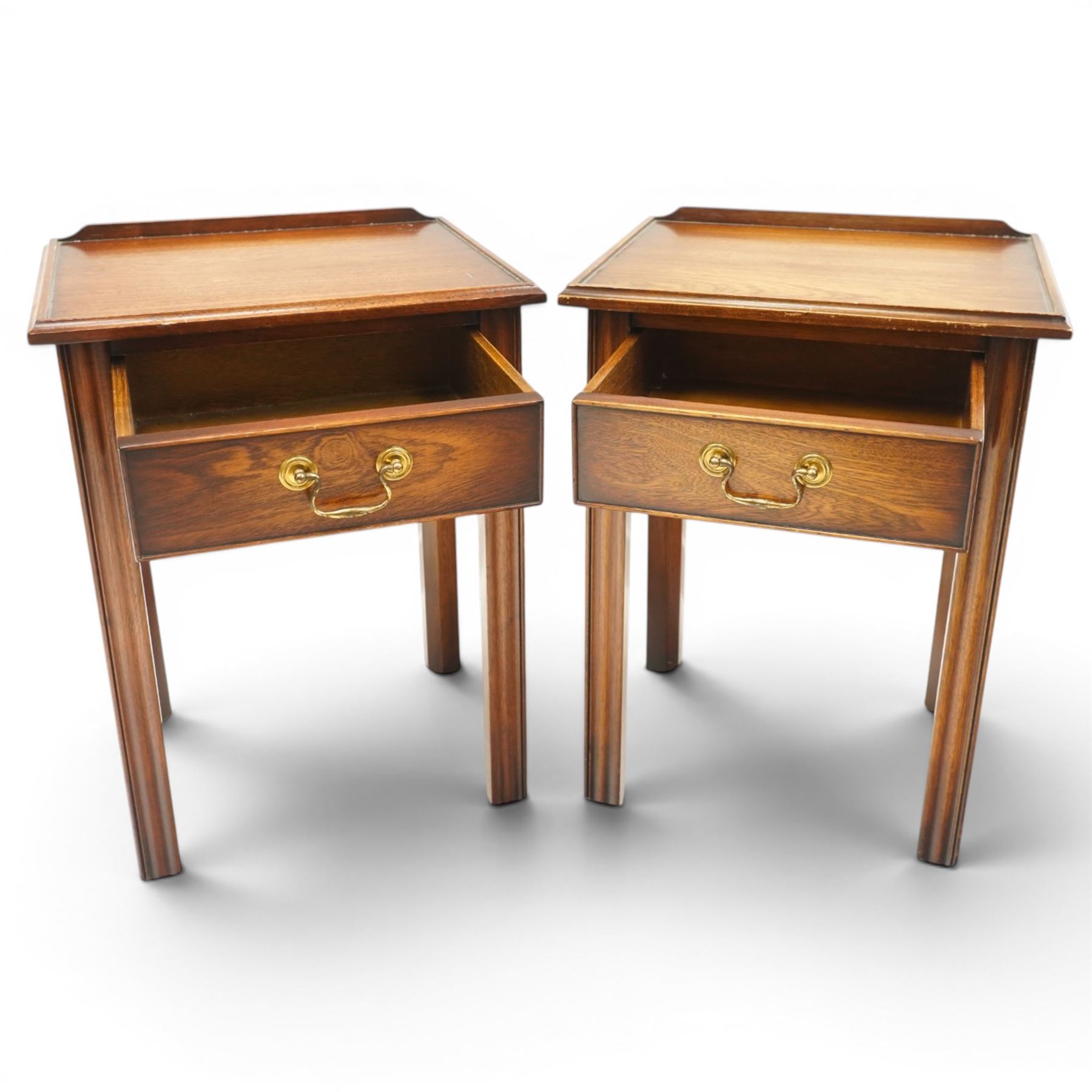 Pair of mahogany bedside tables, with quarter galleried top, single drawer with brass swan neck handle, pierced spandrels on fluted square supports  