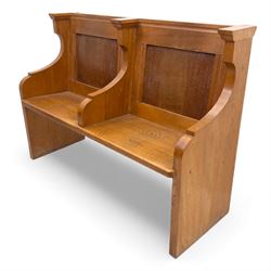 Pair of mid 20th century oak ecclesiastical pews, each with panelled backrests and shaped end supports, of solid construction and mellow honeyed tone