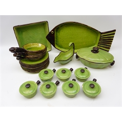  French green glazed dinner service by Etienne Noel comprising nine plates, seven small soup bowls and covers, five handled dishes, sauce boat, tureen and cover, large fish shaped platter, L55cm and square dish   