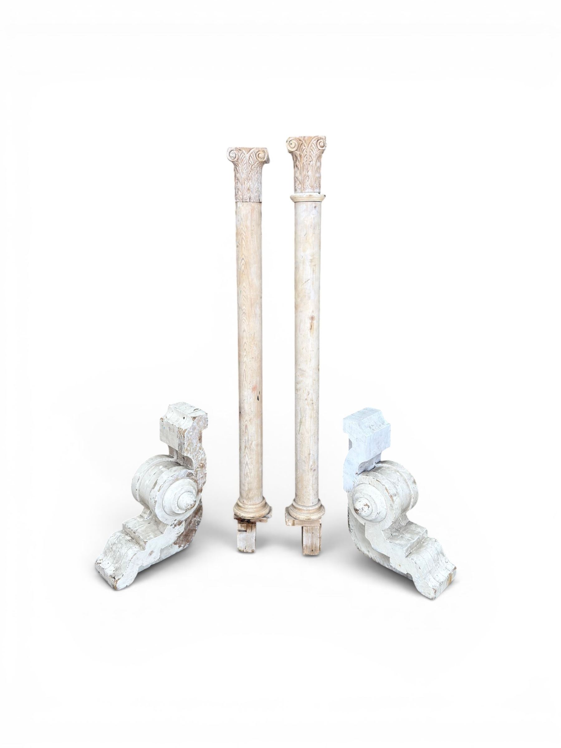 Pair of 19th century stripped pine columns  with carved capitols; an a pair of painted scroll architectural capitols (4)
