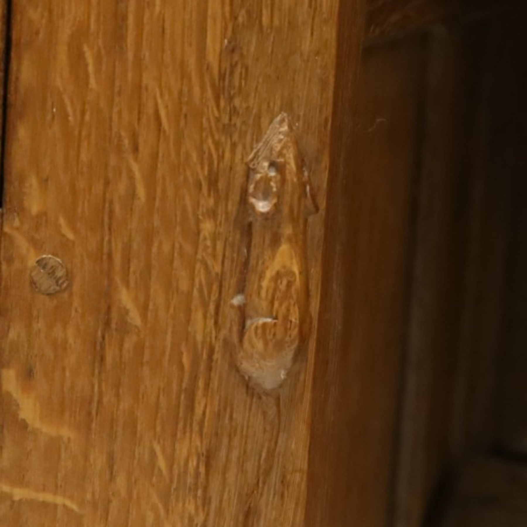 Mouseman - adzed oak kneehole dressing table or desk, the rectangular adzed top with raised back and canted corners, over an arched recessed kneehole flanked by three graduating drawers to each side with turned knob handles, raised on octagonal feet, with carved mouse signature, by the workshop of Robert Thompson of Kilburn