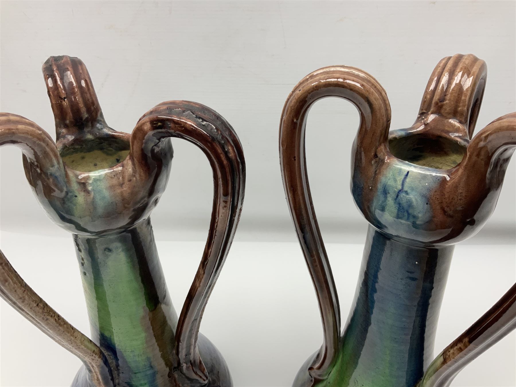 Pair of Art Nouveau style vases, probably Belgian, each with merging blue, brown and green decoration and three handles, impressed LSV beneath, H32cm