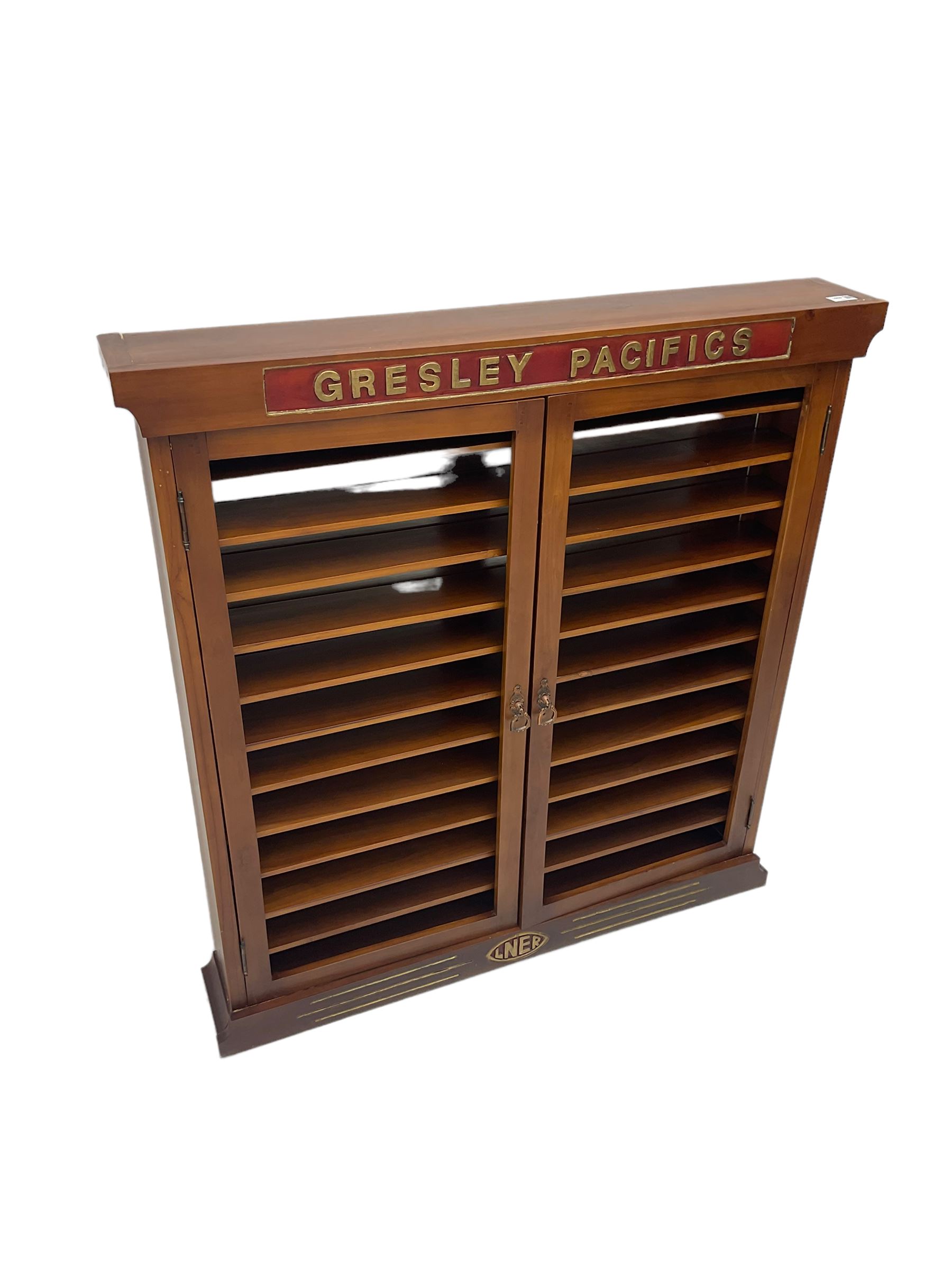 Modern hardwood display cabinet for model railway locomotives inscribed 'Gresley Pacifics' to the frieze and 'LNER' to the bottom rail; with mirrored back and ten loose fitting shelves enclosed by a pair of unglazed doors L101cm H108cm D16cm