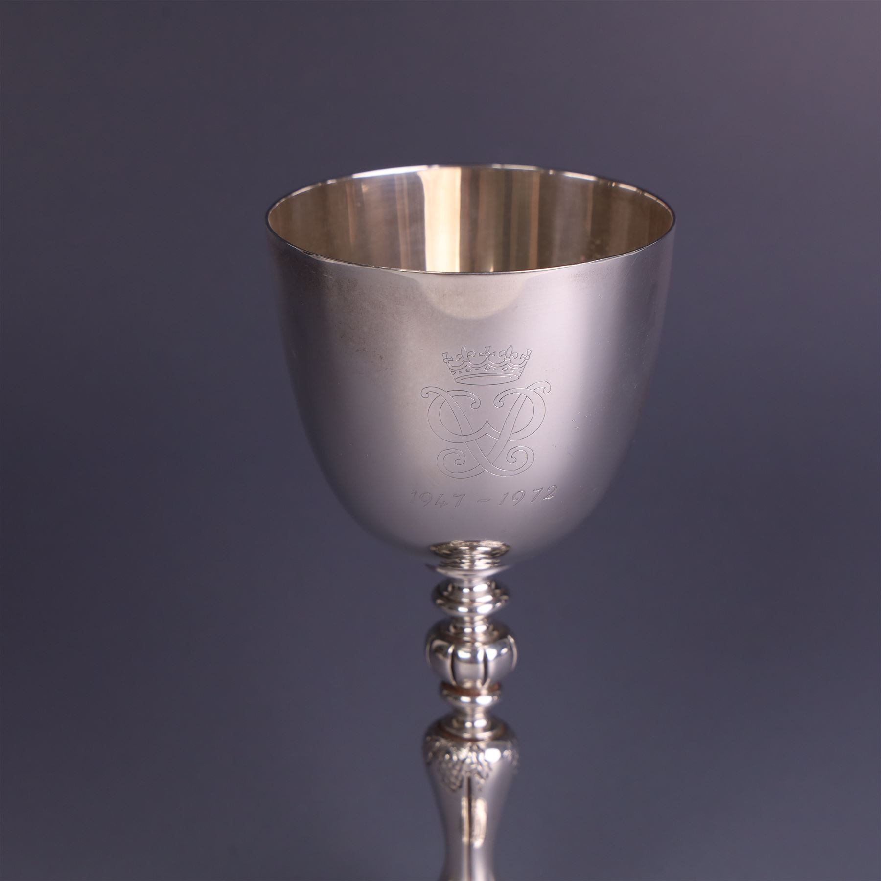 Late 20th century limited edition silver goblet, produced by Garrard & Co Ltd  to commemorate the silver wedding anniversary of Her Majesty Queen Elizabeth II and His Royal Highness the Duke of Edinburgh, the bowl engraved with Royal cyphers and anniversary dates, upon a knopped stem and embossed foot, no. 77/2000, hallmarked Garrard & Co Ltd, London 1972, H15cm