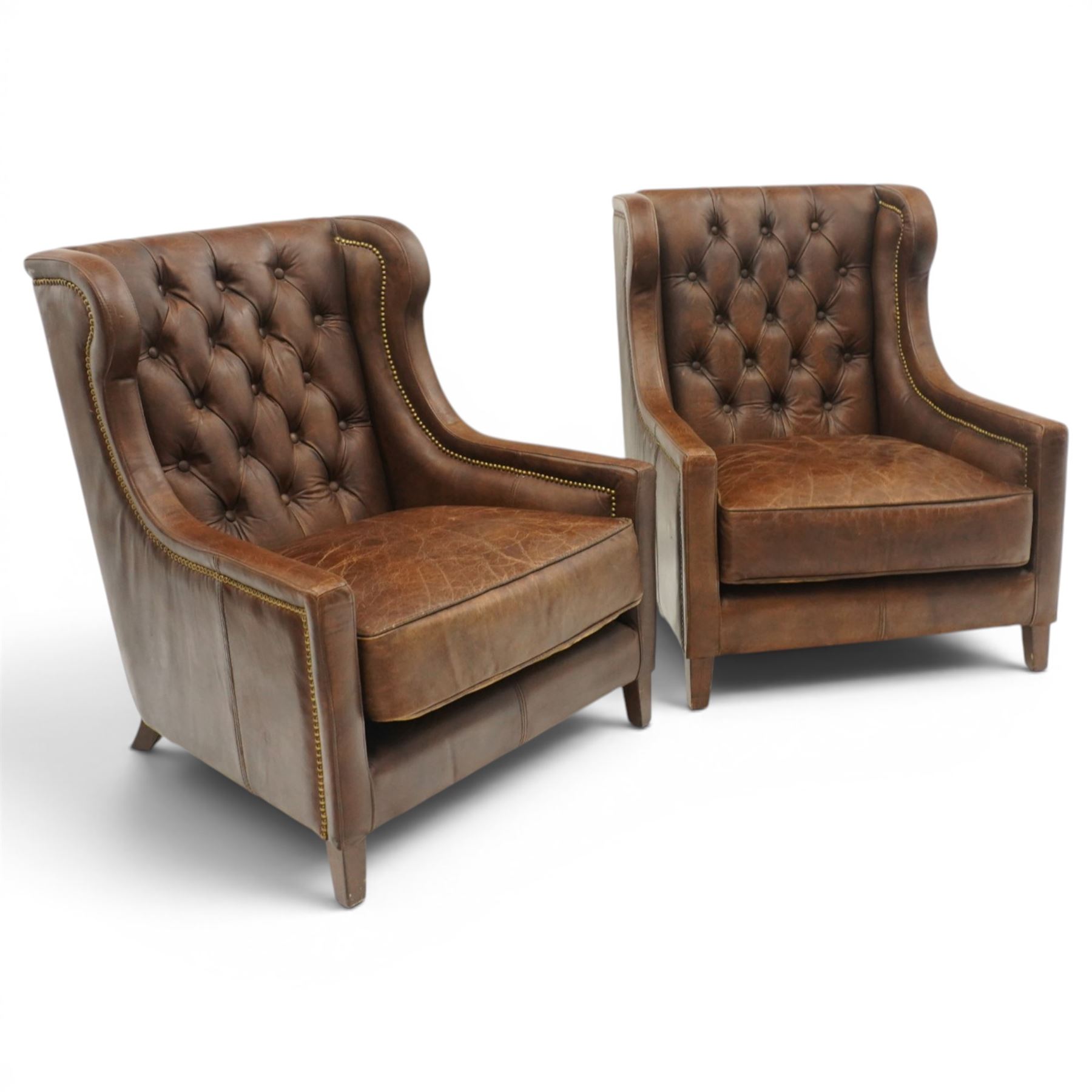 Timothy Oulton - pair of wingback armchairs upholstered in back-buttoned chocolate brown leather with loose seat cushion, raised on square tapering feet