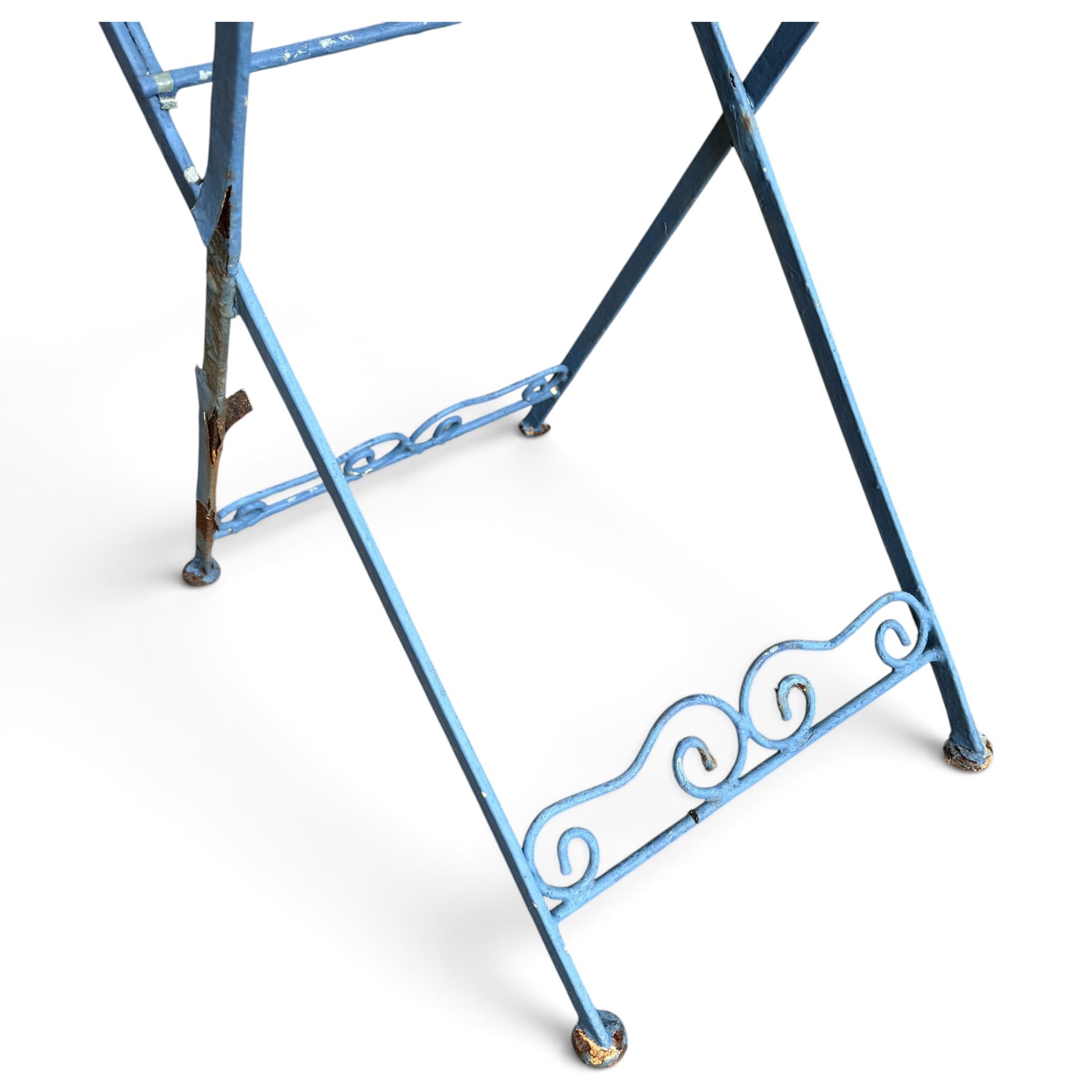 Three-piece French style blue-painted wrought iron garden bistro set, comprising a circular folding table with latticework top and central fruiting grapevine medallion (W71cm H76cm) and matching pair of chairs, with scrolling cresting rail and grapevine motif over folding X-frame base (W40cm H98cm)